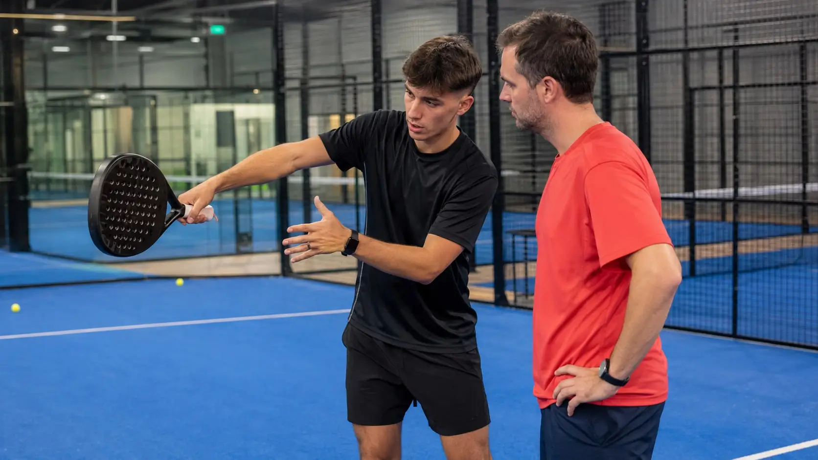 Coach demonstrating a stroke to a player