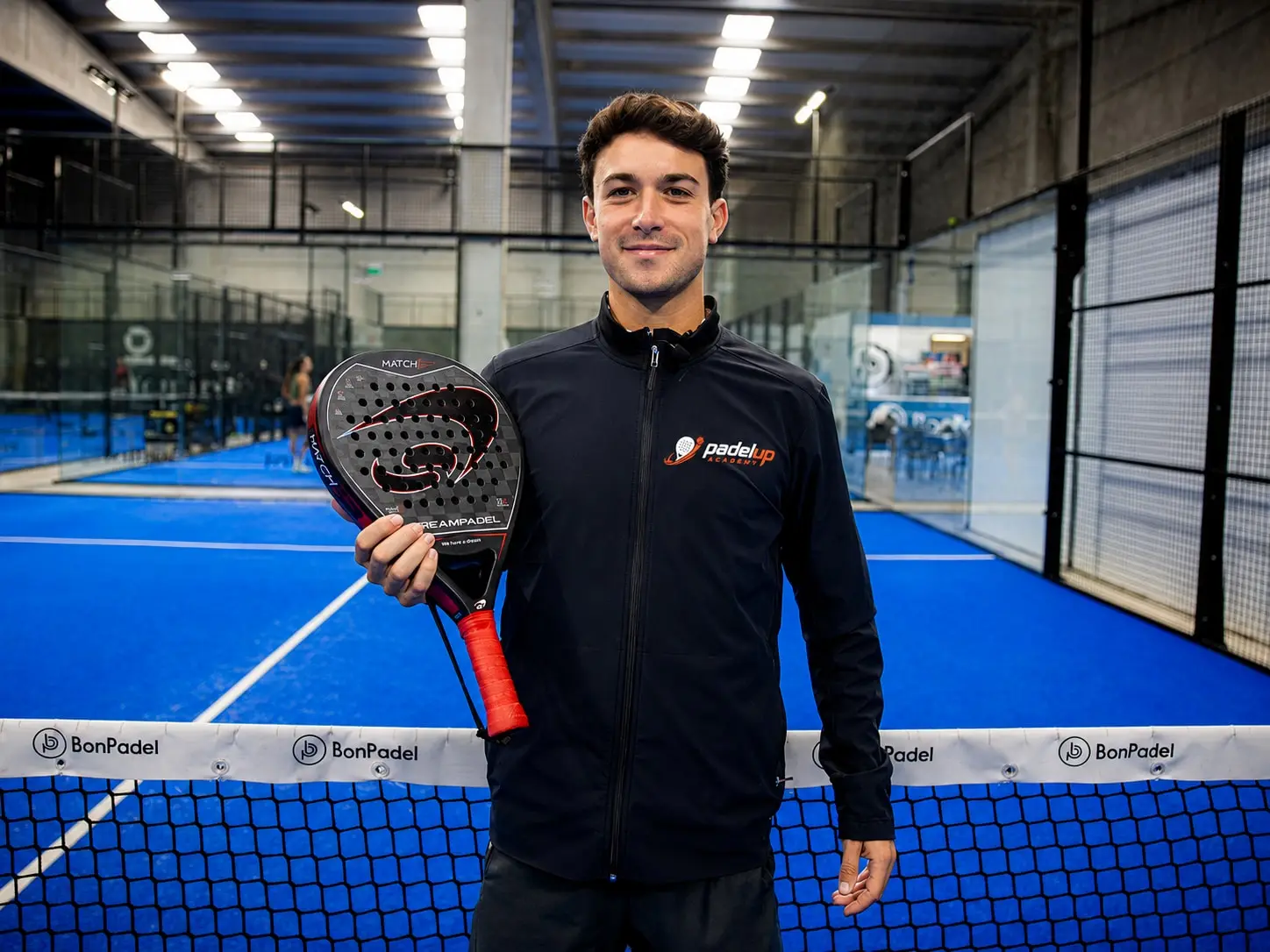 Sergi, padel coach in Valencia, holding a racket on an indoor court